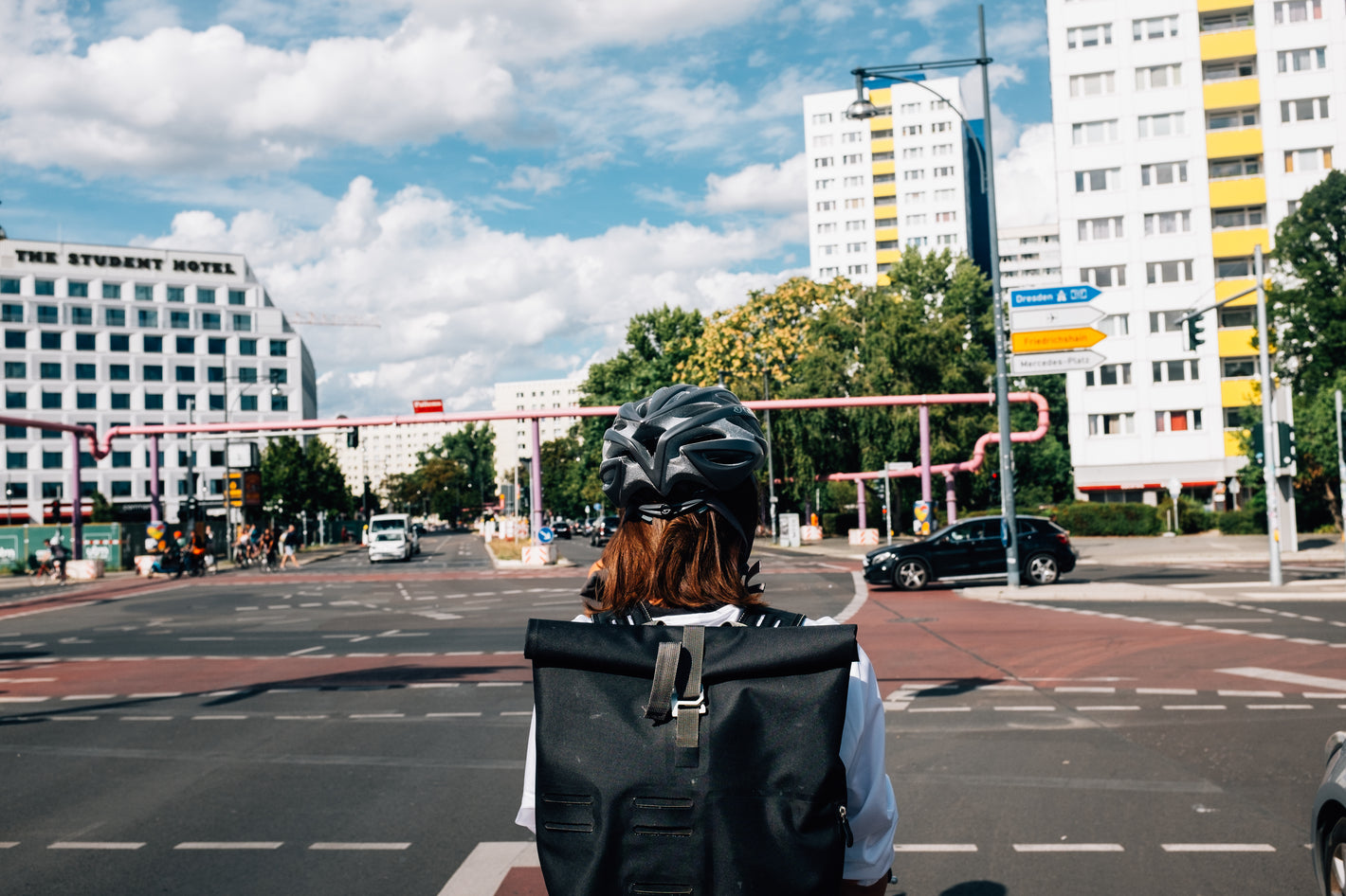 Helmet worn by bike rider waiting for signal to cross intersection